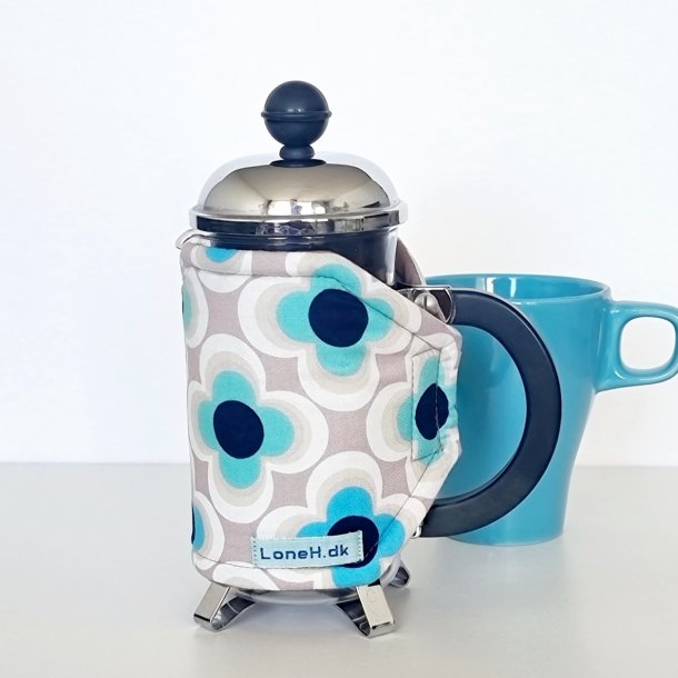 Kaffevarmer i beige med retro blomster