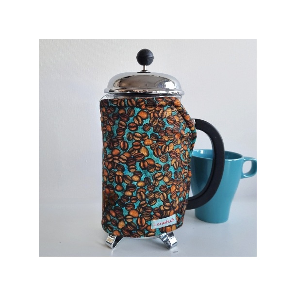 Kaffevarmer med kaffeb�nner p� turkis bund