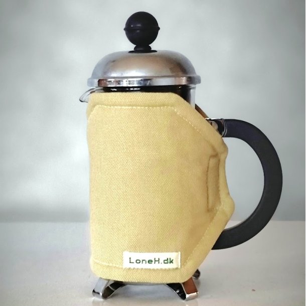 Kaffefrakke i lys okker til en lille stempelkande